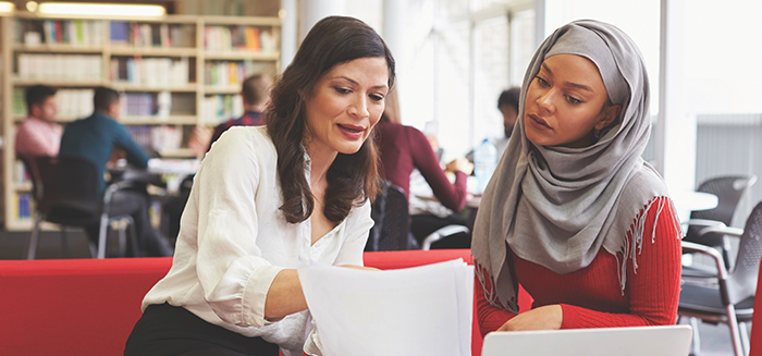 two female managers discussing paperwork